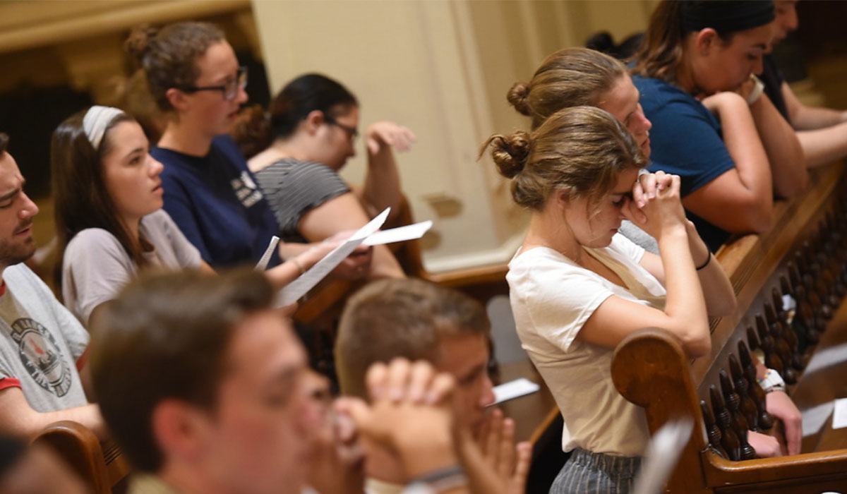 Catholic University students praying 