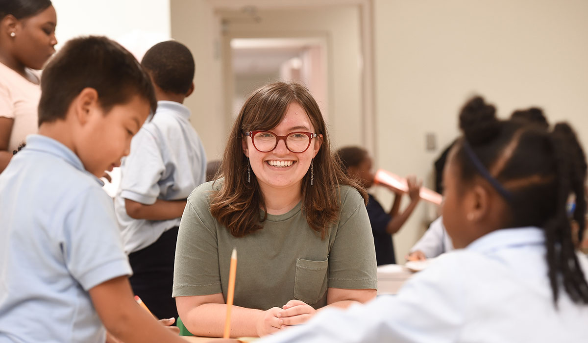 Catholic University student tutoring children 