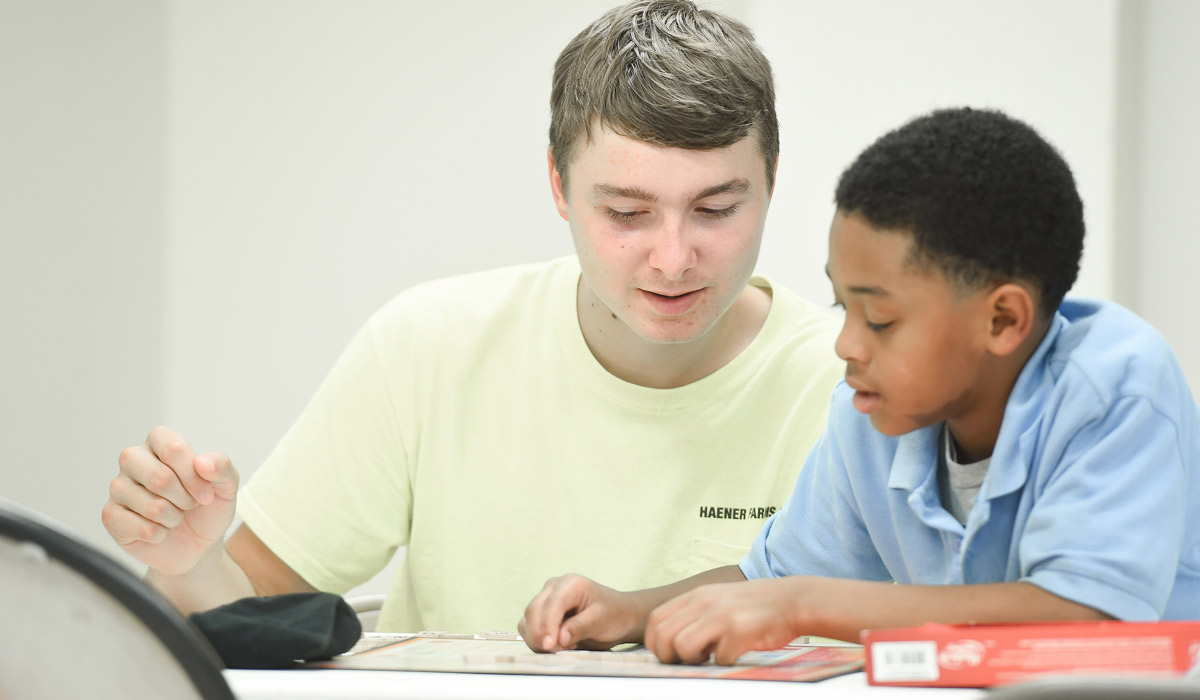 Catholic University Student tutoring child