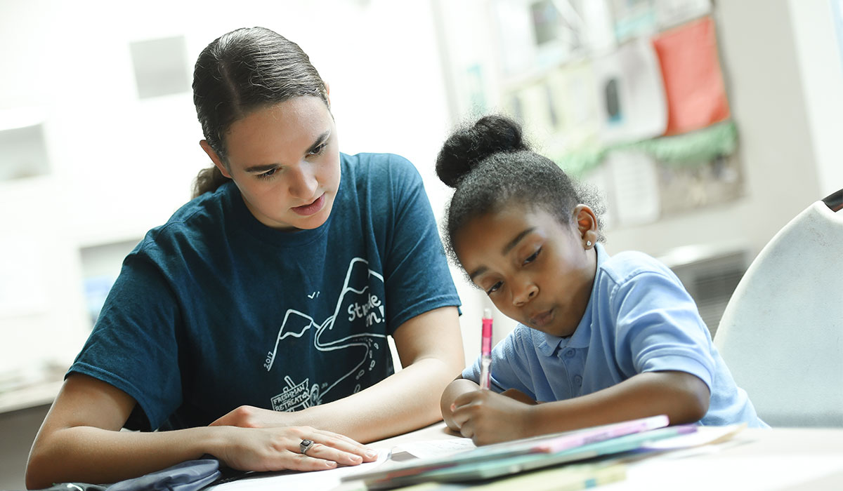 Catholic University student in a one on one tutoring session