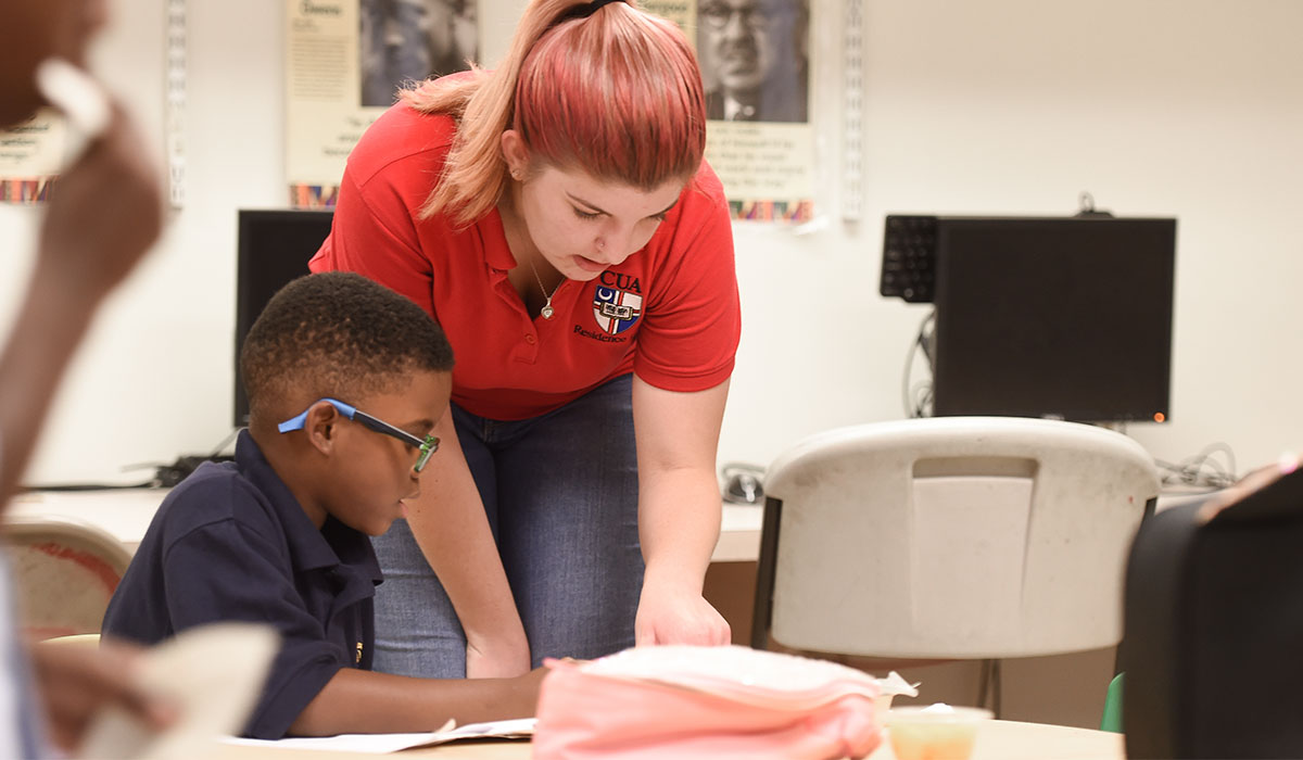 Catholic University student in a one on one tutoring session