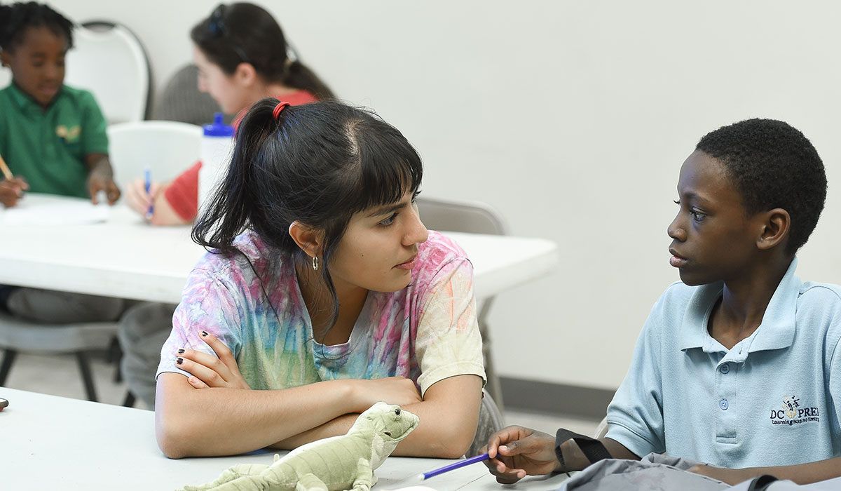 Catholic University student running a tutoring session