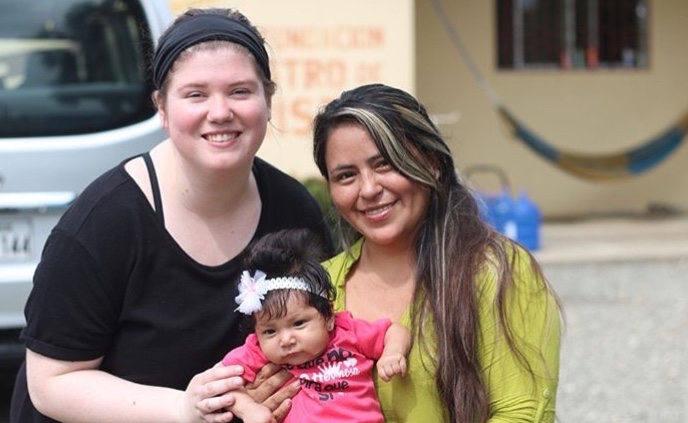Student with Ecuadorian woman and baby