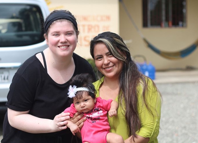 Student with Ecuadorian woman and baby